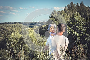 Father embracing daughter looking into the distance countryside scenery horizon