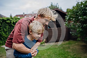 Father embracing his young son, having bonding moment. Concept of Father's Day, and fatherly love.