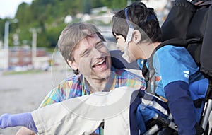 Father enjoying beach with disabled son