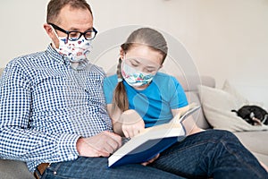 Father enjoys reading a storybook to his little girl.