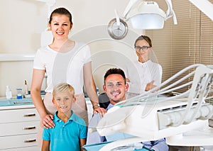 Father of the family is sitting in dental chair