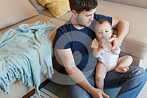 Father feeding baby