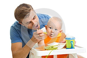 Father feeding baby son