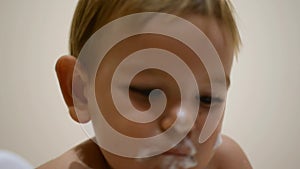 Father feeding baby with spoon. Dairy yogurt meal. Funny toddler face. Messy baby food