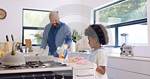 Father, girl and cleaning with gloves in kitchen for bonding, happiness and teaching in home or house. Black family, man