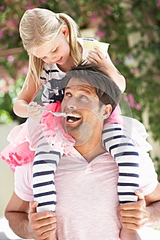 Father Giving Daughter Ride On Shoulders