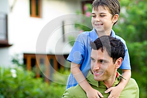 Father giving his son a piggyback ride