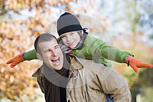 Father giving son piggyback photo