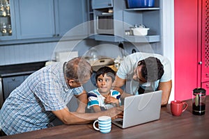 Father and grandfather talking to boy