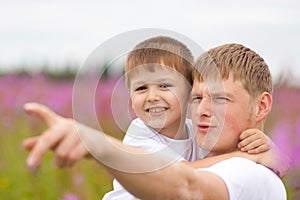 Father and happy son having fun outdoor