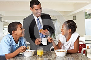 Father Having Breakfast With Children Before Work