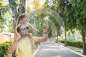 Father is having fun with his little daughter, a walk, summer ho