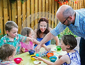 Father Helping Children Dyeing Their Easter Eggs