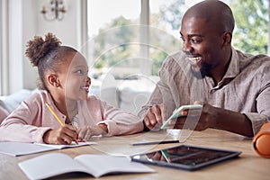 Father Helping Daughter With Home Schooling Sitting At Table With Digital Tablet