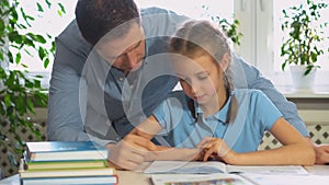 Father helping daughter with homework.