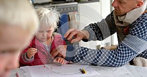Father helping his daughter in drawing at home 4k