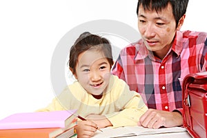 Father helping his daugther doing homework