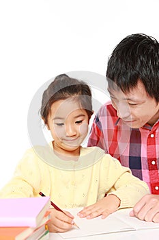 Father helping his daugther doing homework