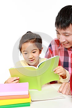 Father helping his daugther doing homework