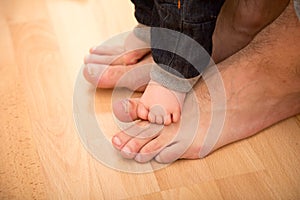 Father helping his son for the first steps