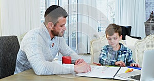 Father helping his son with homework 4k