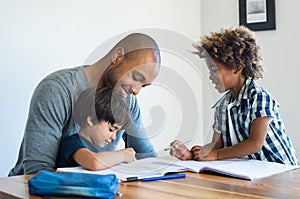 Father helping his sons with homework