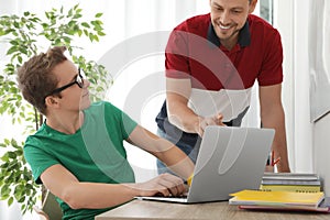 Father helping his teenager son with homework