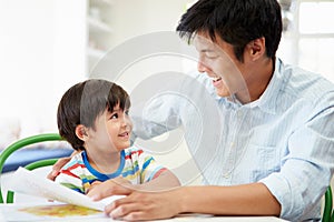 Father Helping Son With Homework