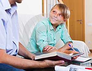 Father helping son to do homework