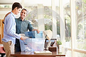 Father Helping Teenage Son Pack For College