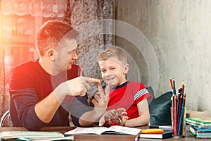 The father helps his son to do homework for the school