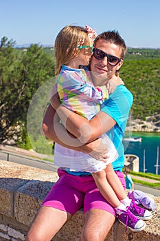 Father and her little daughter outdoors in