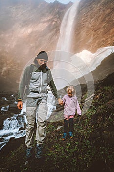 Father hiking with child outdoor family active healthy lifestyle traveling in Norway summer vacations