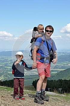 Father hiking with children