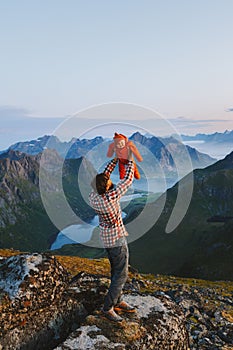 Father hiking with infant baby outdoor family active healthy lifestyle traveling in Norway summer vacations