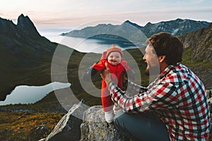 Father hiking with infant baby travel family healthy lifestyle adventure vacations trip in mountains