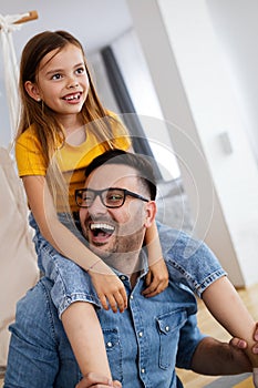 Father and his daughter child girl playing together. Father`s day concept.