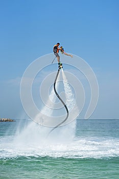 Father and his daughter posing at new flyboard at Caribbean tropical beach. Positive human emotions, feelings, joy. Funny cute chi