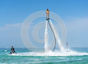 Father and his daughter posing at new flyboard at Caribbean tropical beach. Positive human emotions, feelings, joy. Funny cute chi