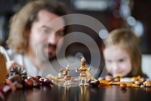 Father and his kid making chestnuts creatures