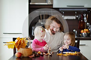 Father and his kids making chestnuts creatures