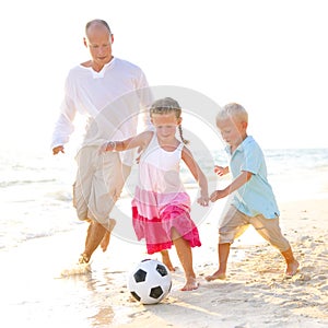 Father and his kids playing football together