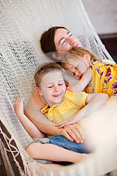 Father and his kids relaxing in hammock