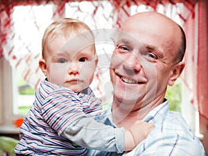 Father with his little baby son portrait in home