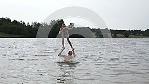 Father and his little daughter having fun on lake