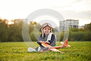 Father with his little son playing with toy plane on the field