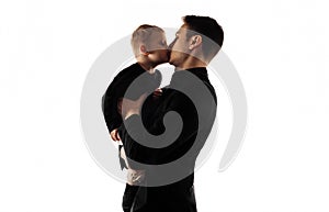 Father and his little son on a white background. Happy father with his son, a small child kisses his father and hugs