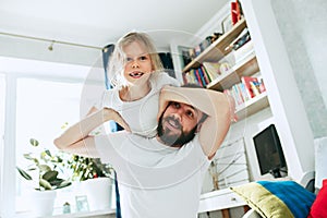 Father and his six years kid girl at home