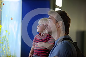 Father and his son enjoying views of underwater life