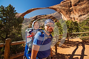 Father with his son in front of Landscape arch in Arches Natio